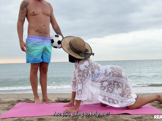 Pretty latina Alika Penagos tries to do a yoga video on the beach